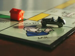 A monopoly board with a toy car on top.