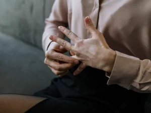 A woman taking off her wedding ring.