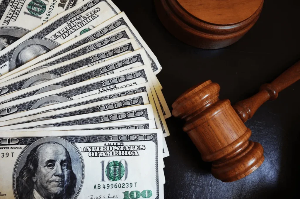 A gavel sitting on a desk next to a pile of 100-dollar bills. If you are facing a high asset divorce and don’t know what step to take next our female divorce lawyer has years of experience navigating the intricacies of family court and will help you obtain a fair settlement.