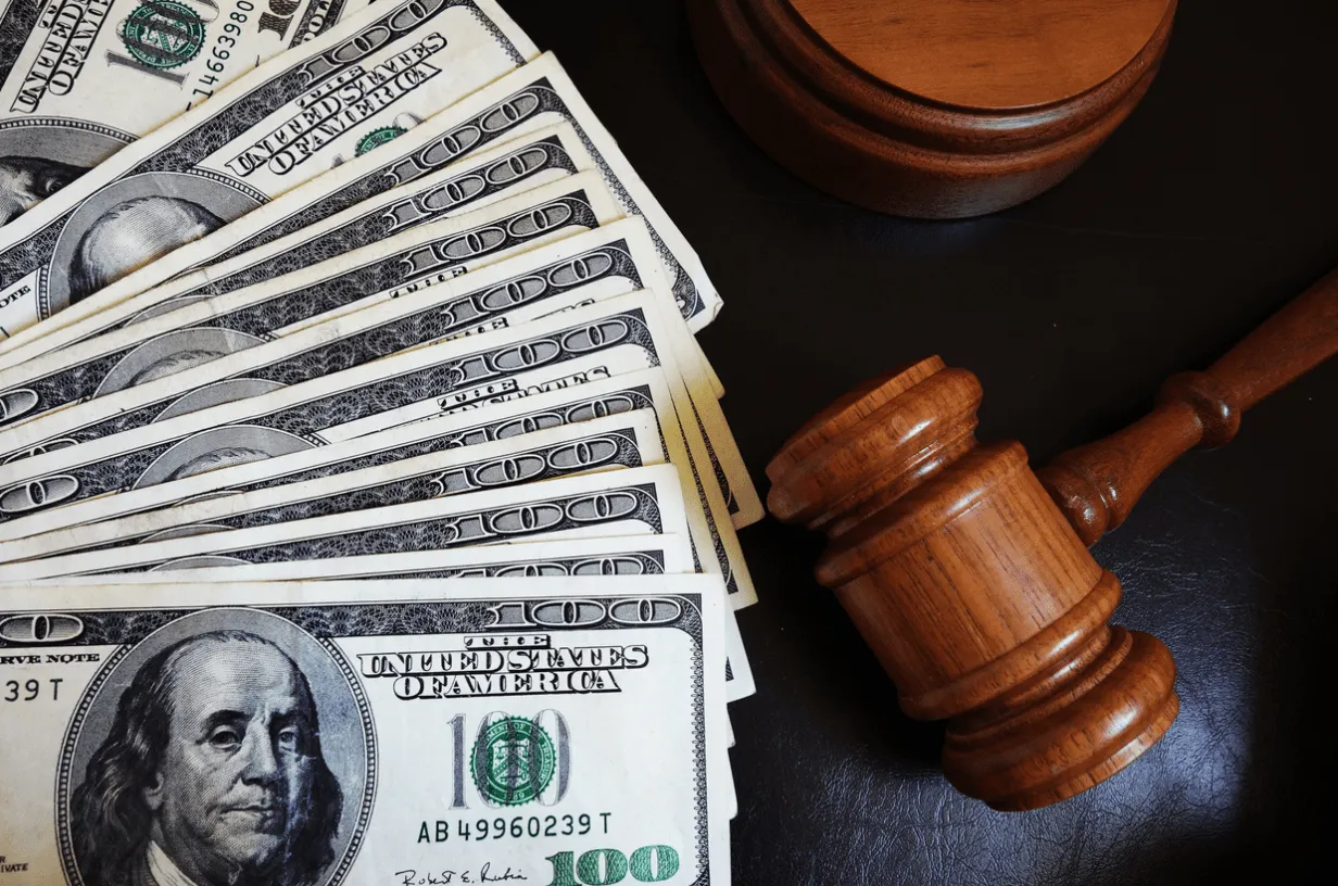 A gavel sitting on a desk next to a pile of 100-dollar bills. If you are facing a high asset divorce and don’t know what step to take next our female divorce lawyer has years of experience navigating the intricacies of family court and will help you obtain a fair settlement.