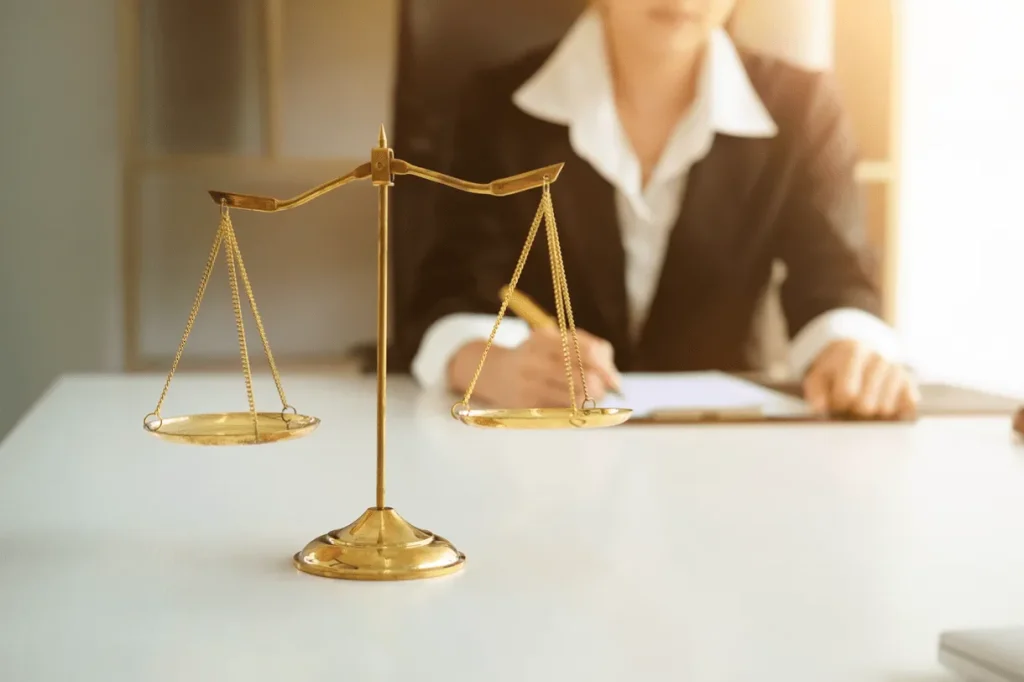 A female divorce lawyer for women in Cincinnati sitting at her desk looking over legal documents for a high asset divorce and child custody case. Our talented attorneys are here to help women obtain a fair outcome when facing divorce.