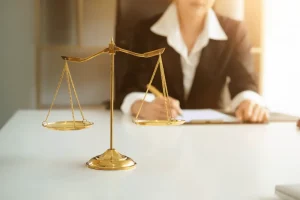 A female divorce lawyer for women in Cincinnati sitting at her desk looking over legal documents for a high asset divorce and child custody case. Our talented attorneys are here to help women obtain a fair outcome when facing divorce.