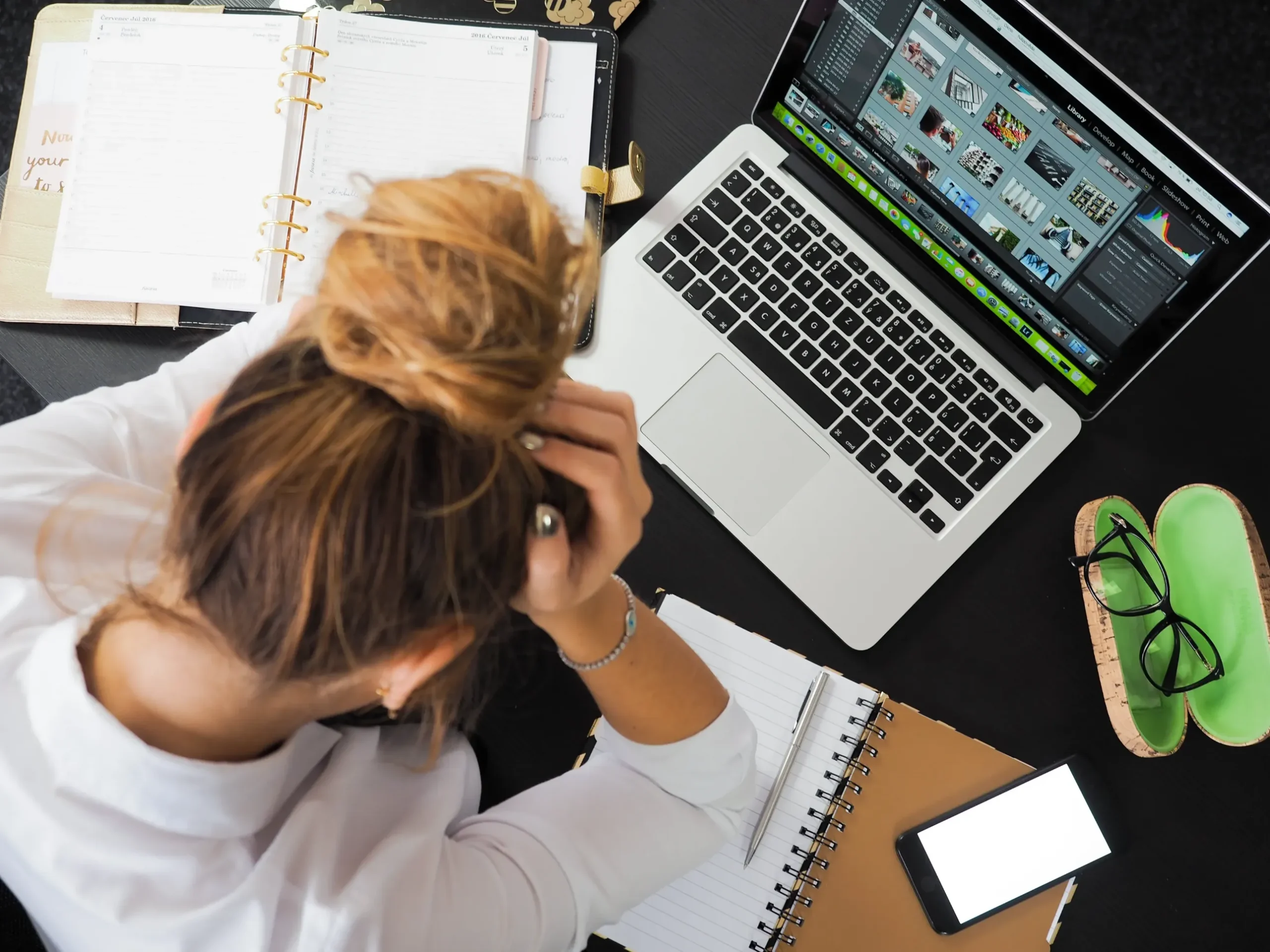 A stressed woman looking at a computer.