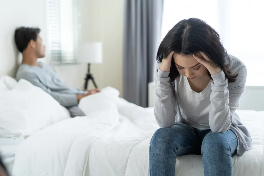 A distressed woman next to her husband.