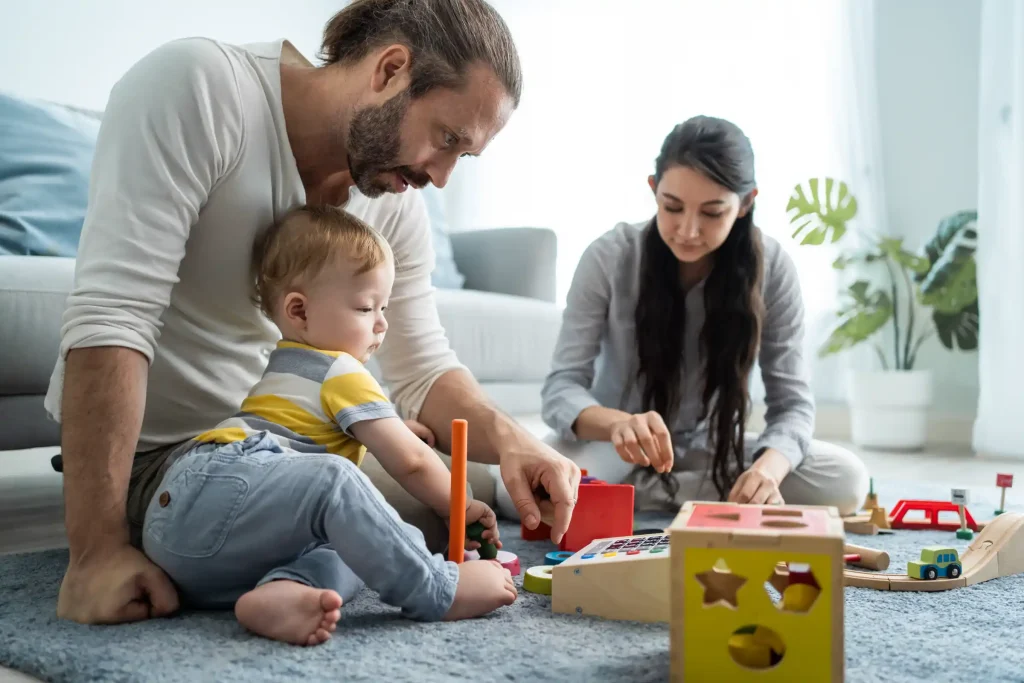 Two parents playing with their child.
