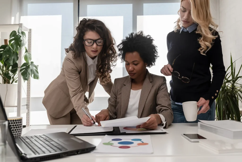 Diverse group of women entrepreneurs discussing a project in an office.