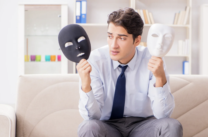 Man holding two masks, deciding which one to wear.