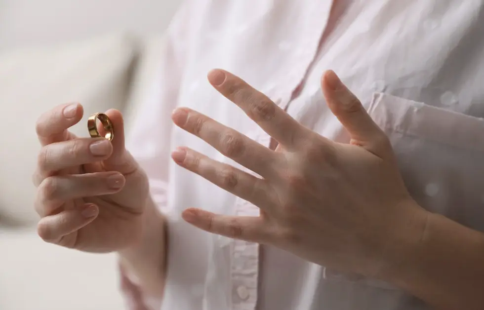 Woman holds her wedding ring.